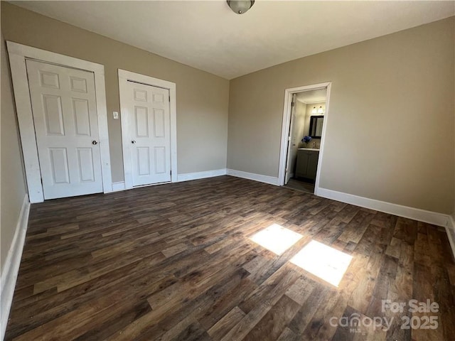 168 Grove St, Mocksville, NC 27028 - unfurnished bedroom with dark wood-style flooring, baseboards, and ensuite bathroom