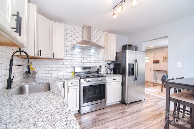 3623 Braden Dr, Charlotte, NC 28216 - kitchen featuring stainless steel appliances, wall chimney range hood, a sink, and backsplash