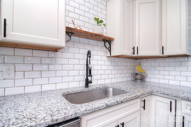 3623 Braden Dr, Charlotte, NC 28216 - kitchen with a sink, decorative backsplash, white cabinetry, and open shelves