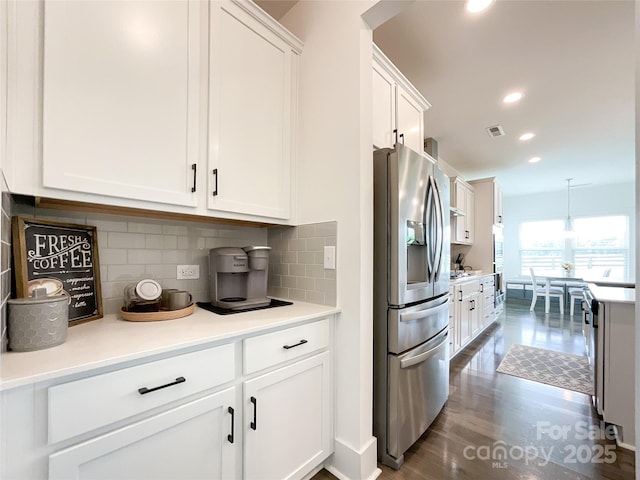 kitchen featuring stainless steel fridge, white cabinetry, backsplash, dark wood-style flooring, and recessed lighting