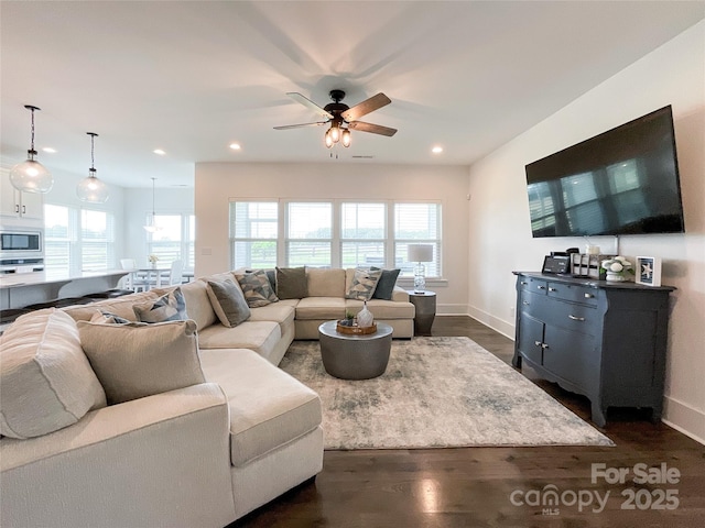 living area with plenty of natural light, a ceiling fan, baseboards, and recessed lighting