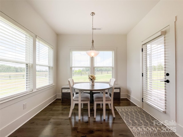 dining room featuring dark wood-style floors and baseboards