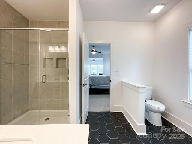 full bath featuring toilet, baseboards, a shower stall, and tile patterned flooring