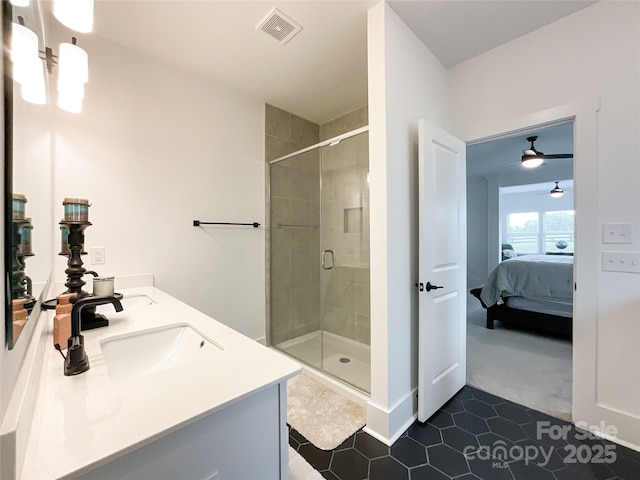 ensuite bathroom featuring a stall shower, tile patterned flooring, a ceiling fan, and double vanity