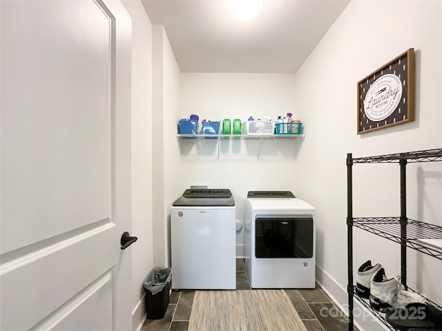washroom with washer and dryer and baseboards