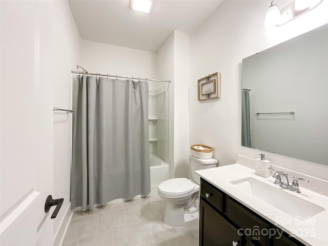 bathroom featuring toilet, vanity, shower / bath combo with shower curtain, and tile patterned floors
