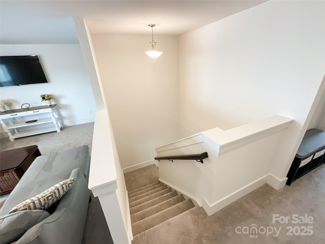 stairs featuring carpet and baseboards