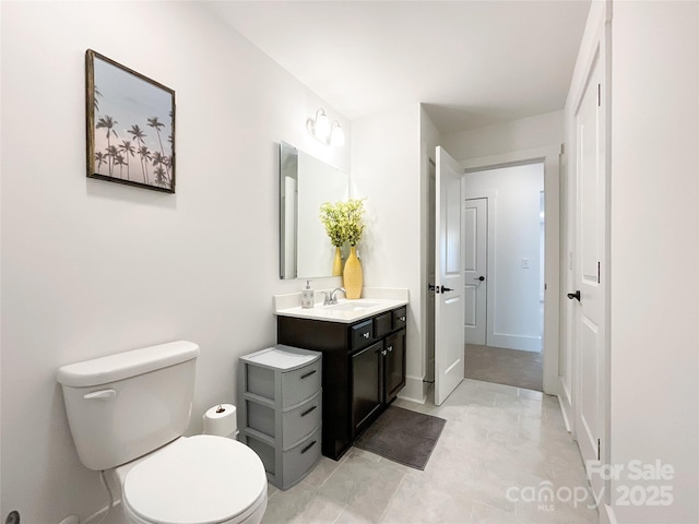 bathroom with toilet and vanity