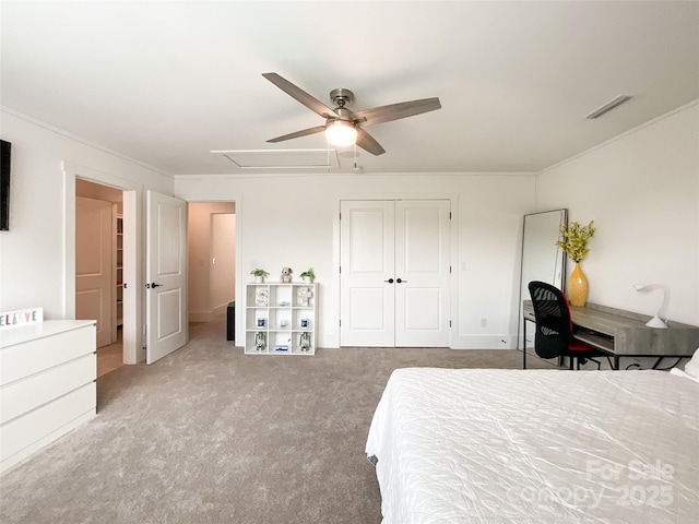 bedroom with a closet, carpet flooring, ceiling fan, and ornamental molding