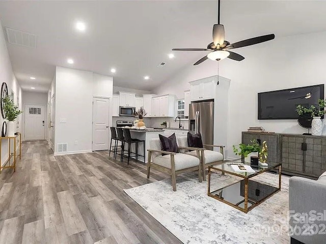 1604 N Main St, Mount Holly, NC 28120 - living area with ceiling fan, light wood-type flooring, high vaulted ceiling, and recessed lighting