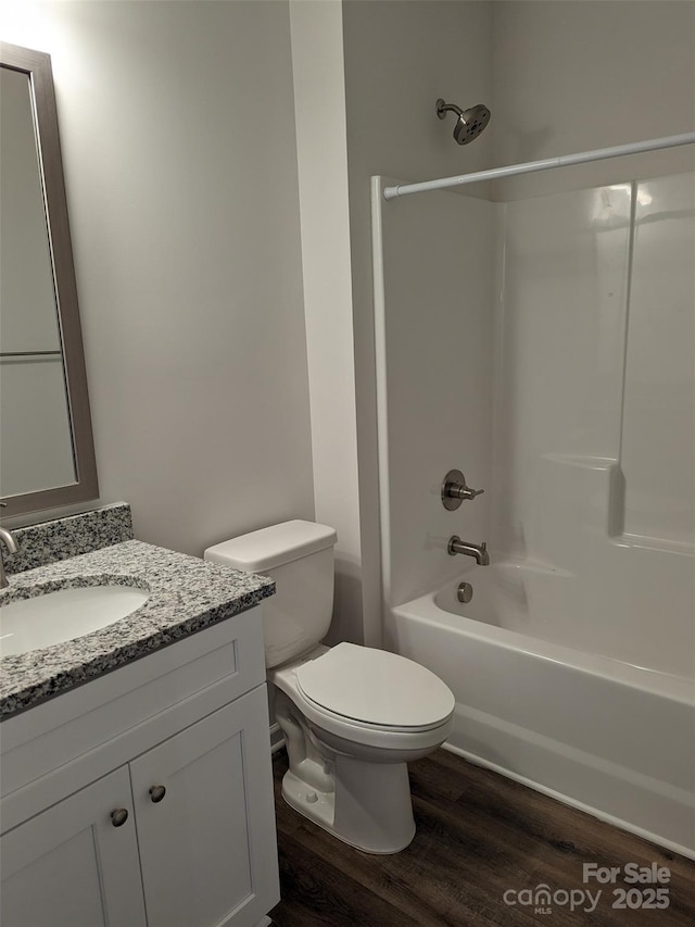 1604 N Main St, Mount Holly, NC 28120 - full bathroom featuring wood finished floors, toilet, vanity, and bathing tub / shower combination