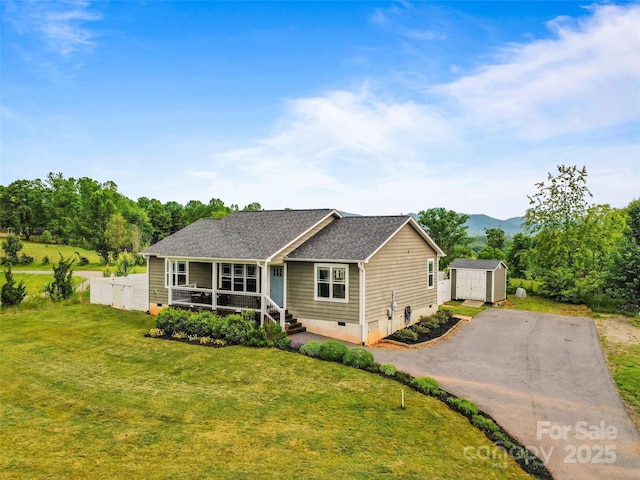 128 Lewis Ln, Candler, NC 28715 - view of front of property with a front lawn, roof with shingles, a porch, asphalt driveway, and a mountain view