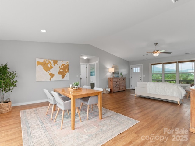 128 Lewis Ln, Candler, NC 28715 - dining space with lofted ceiling, light wood finished floors, ceiling fan, and baseboards