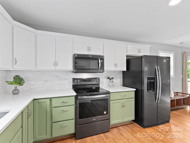128 Lewis Ln, Candler, NC 28715 - kitchen with appliances with stainless steel finishes, green cabinets, white cabinets, and light wood-type flooring