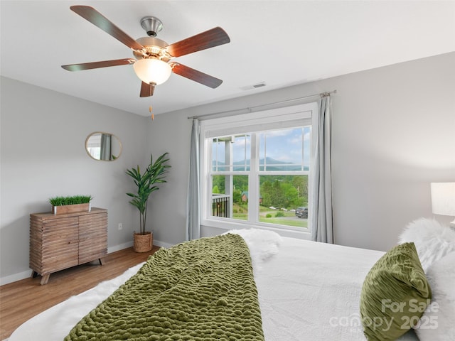 128 Lewis Ln, Candler, NC 28715 - bedroom featuring wood finished floors, baseboards, and a ceiling fan