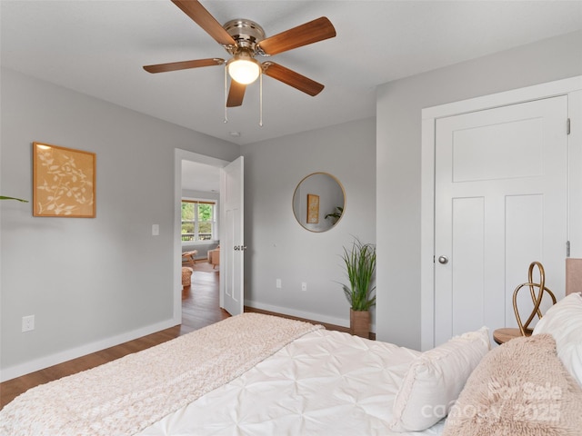 128 Lewis Ln, Candler, NC 28715 - bedroom featuring dark wood-style flooring, baseboards, and a ceiling fan