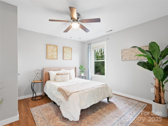 128 Lewis Ln, Candler, NC 28715 - bedroom with wood finished floors, baseboards, and a ceiling fan