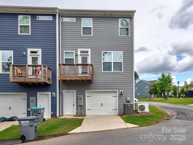 2001 Laurel Village Cir, Belmont, NC 28012 - view of front of property featuring a cooling unit, a garage, central air condition unit, a balcony, and driveway