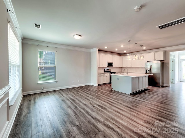 2001 Laurel Village Cir, Belmont, NC 28012 - kitchen featuring stainless steel appliances, a sink, open floor plan, crown molding, and decorative backsplash