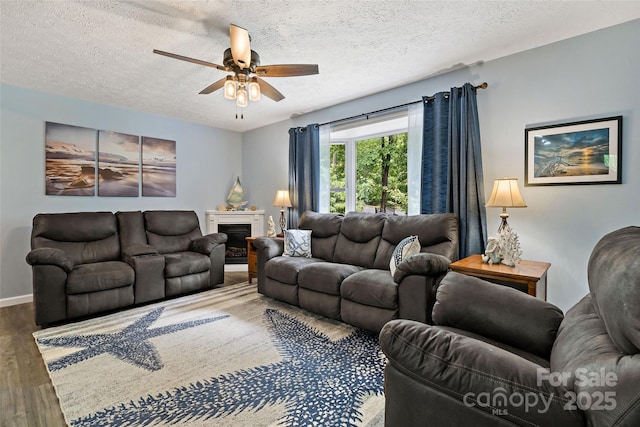 174 Sassafras Hill Dr Unit 41, Rutherfordton, NC 28139 - living room with ceiling fan, wood finished floors, a textured ceiling, baseboards, and a fireplace