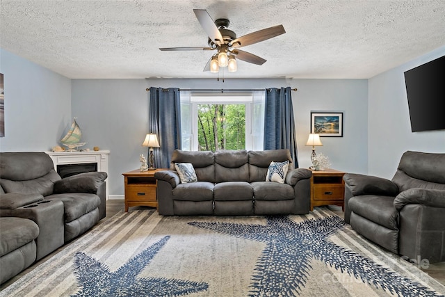 174 Sassafras Hill Dr Unit 41, Rutherfordton, NC 28139 - living room featuring a ceiling fan, a textured ceiling, a fireplace, and wood finished floors