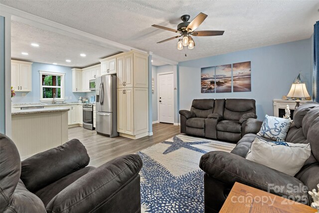 174 Sassafras Hill Dr Unit 41, Rutherfordton, NC 28139 - living room featuring a textured ceiling, light wood-style flooring, ceiling fan, recessed lighting, and baseboards