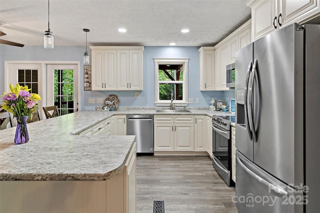 174 Sassafras Hill Dr Unit 41, Rutherfordton, NC 28139 - kitchen featuring appliances with stainless steel finishes, a sink, light countertops, plenty of natural light, and a textured ceiling