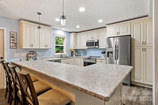 174 Sassafras Hill Dr Unit 41, Rutherfordton, NC 28139 - kitchen featuring stainless steel appliances, a sink, light wood-style floors, a breakfast bar area, and recessed lighting