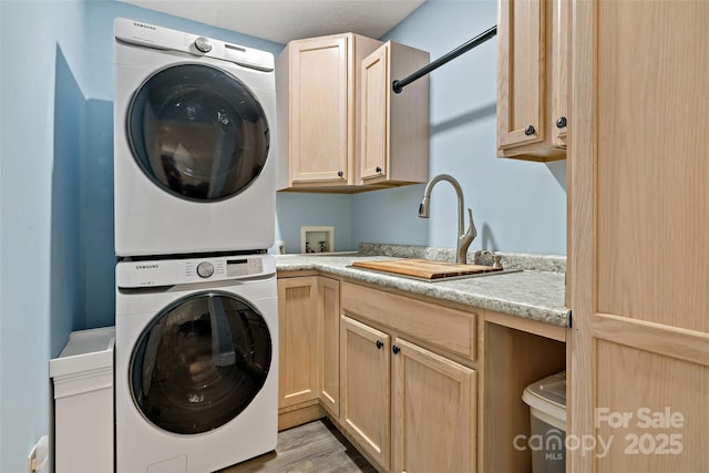 174 Sassafras Hill Dr Unit 41, Rutherfordton, NC 28139 - laundry room with stacked washer / drying machine, cabinet space, and light wood finished floors
