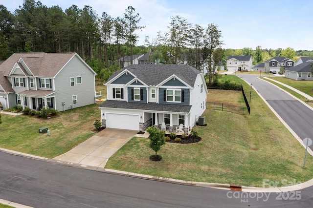 view of front of home featuring driveway, a porch, an attached garage, central AC unit, and stone siding