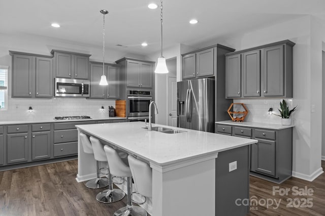 7604 Tanglewood Way, Denver, NC 28037 - kitchen with appliances with stainless steel finishes, gray cabinets, decorative backsplash, an island with sink, and recessed lighting