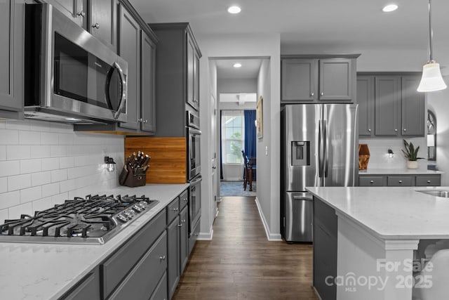 7604 Tanglewood Way, Denver, NC 28037 - kitchen with stainless steel appliances, dark wood finished floors, light stone countertops, gray cabinets, and tasteful backsplash