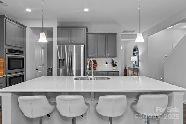 7604 Tanglewood Way, Denver, NC 28037 - kitchen featuring appliances with stainless steel finishes, gray cabinetry, decorative backsplash, light stone countertops, and recessed lighting
