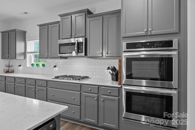 7604 Tanglewood Way, Denver, NC 28037 - kitchen with appliances with stainless steel finishes, gray cabinets, tasteful backsplash, and dark wood-style flooring