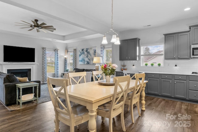7604 Tanglewood Way, Denver, NC 28037 - dining room with dark wood-style floors, recessed lighting, a glass covered fireplace, a tray ceiling, and ceiling fan