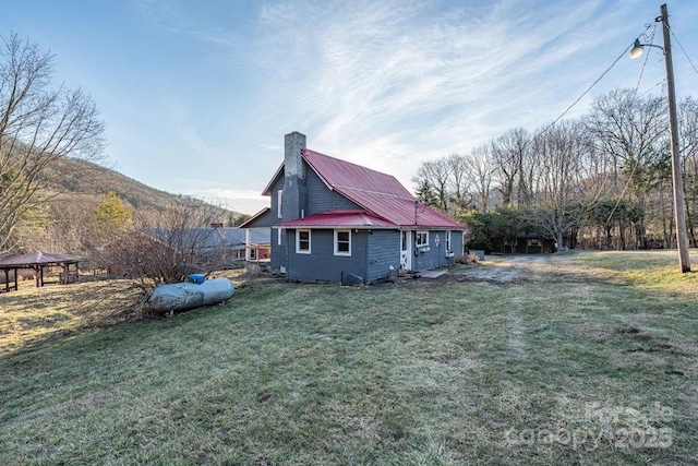 40 Painter Rd, Banner Elk, NC 28604 - view of property exterior featuring a chimney, a gazebo, a yard, and metal roof