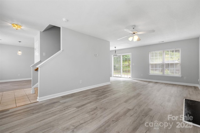 4004 Shasta Cir, Clover, SC 29710 - unfurnished living room featuring a ceiling fan, wood finished floors, stairway, and baseboards
