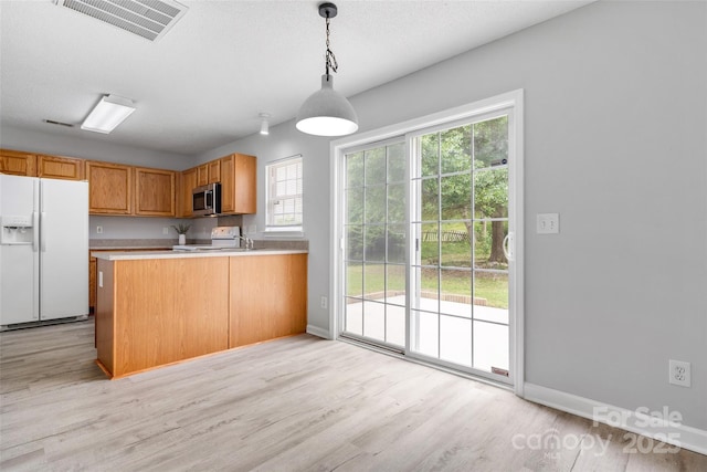 4004 Shasta Cir, Clover, SC 29710 - kitchen with white fridge with ice dispenser, light wood finished floors, electric range, light countertops, and hanging light fixtures