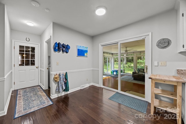 doorway to outside with wood finished floors and baseboards