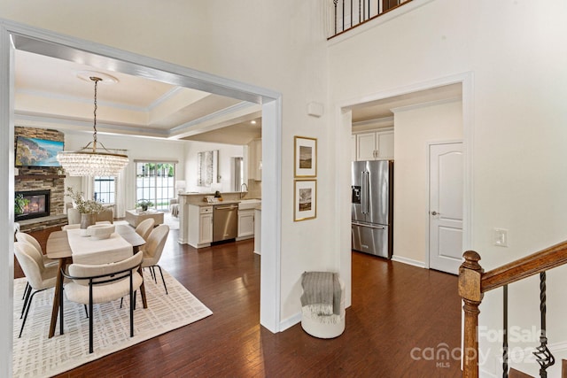 4028 Woodsmill Rd, Fort Mill, SC 29707 - dining room with dark wood-style flooring, ornamental molding, a tray ceiling, baseboards, and a chandelier