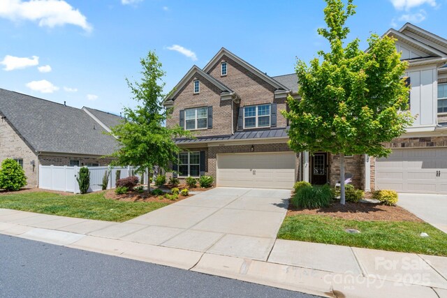 4028 Woodsmill Rd, Fort Mill, SC 29707 - view of front of home featuring fence, brick siding, driveway, a garage, and a standing seam roof