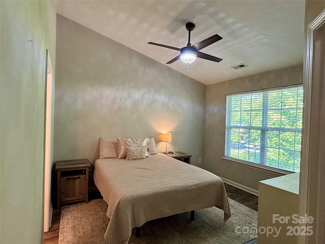 bedroom featuring wood finished floors, baseboards, ceiling fan, and vaulted ceiling