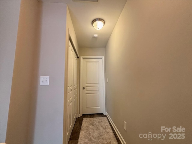 hallway featuring baseboards