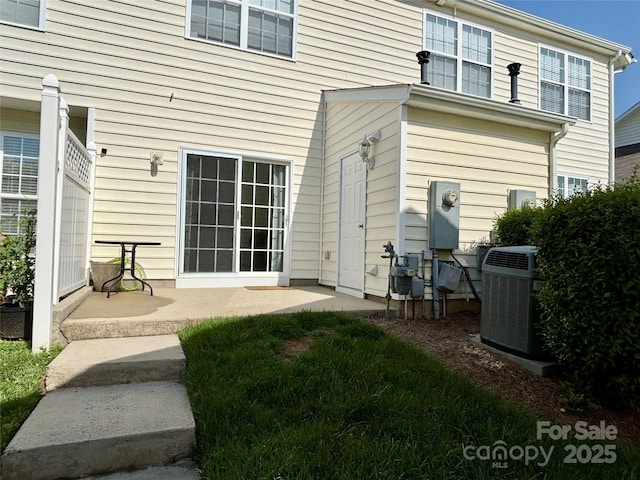 rear view of property featuring central AC unit