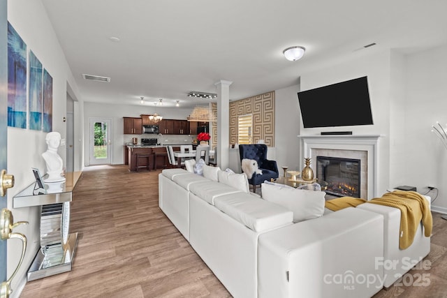 9132 Colwick Hill Ln, Charlotte, NC 28215 - living area with a glass covered fireplace and light wood finished floors
