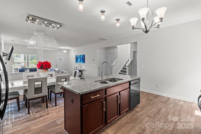 9132 Colwick Hill Ln, Charlotte, NC 28215 - kitchen featuring a sink, dishwasher, a chandelier, and wood finished floors