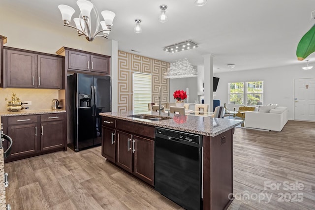 9132 Colwick Hill Ln, Charlotte, NC 28215 - kitchen featuring black appliances, a sink, open floor plan, a kitchen island with sink, and dark brown cabinetry