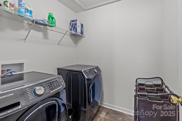 9132 Colwick Hill Ln, Charlotte, NC 28215 - washroom with washer and dryer, baseboards, and dark stone finish floors
