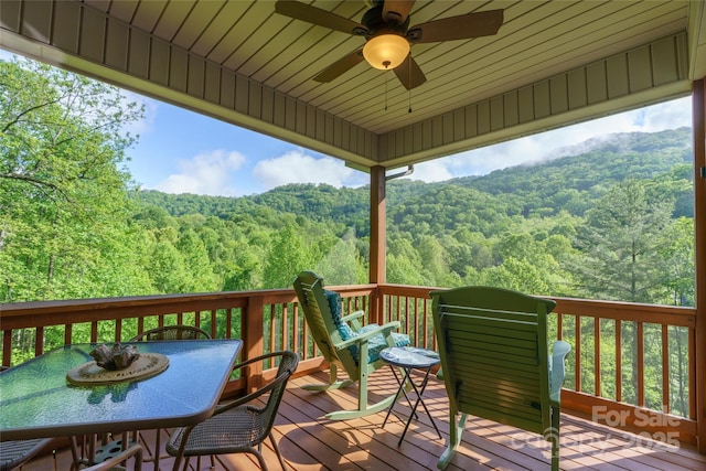 332 Mystic Cv, Waynesville, NC 28785 - wooden deck featuring a wooded view, ceiling fan, and outdoor dining area