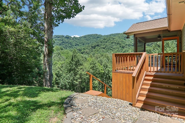332 Mystic Cv, Waynesville, NC 28785 - view of green lawn with a wooded view, ceiling fan, and a wooden deck